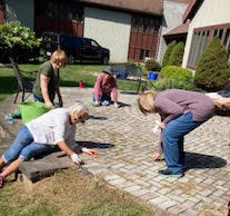 Volunteers working on church lawn